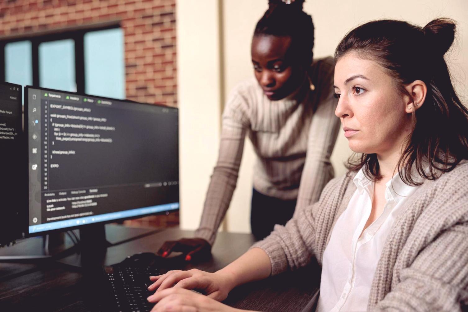 Mobile app development workspace showing code on multiple screens